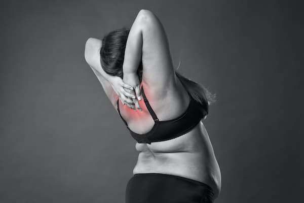 An image of a woman having lower neck pain